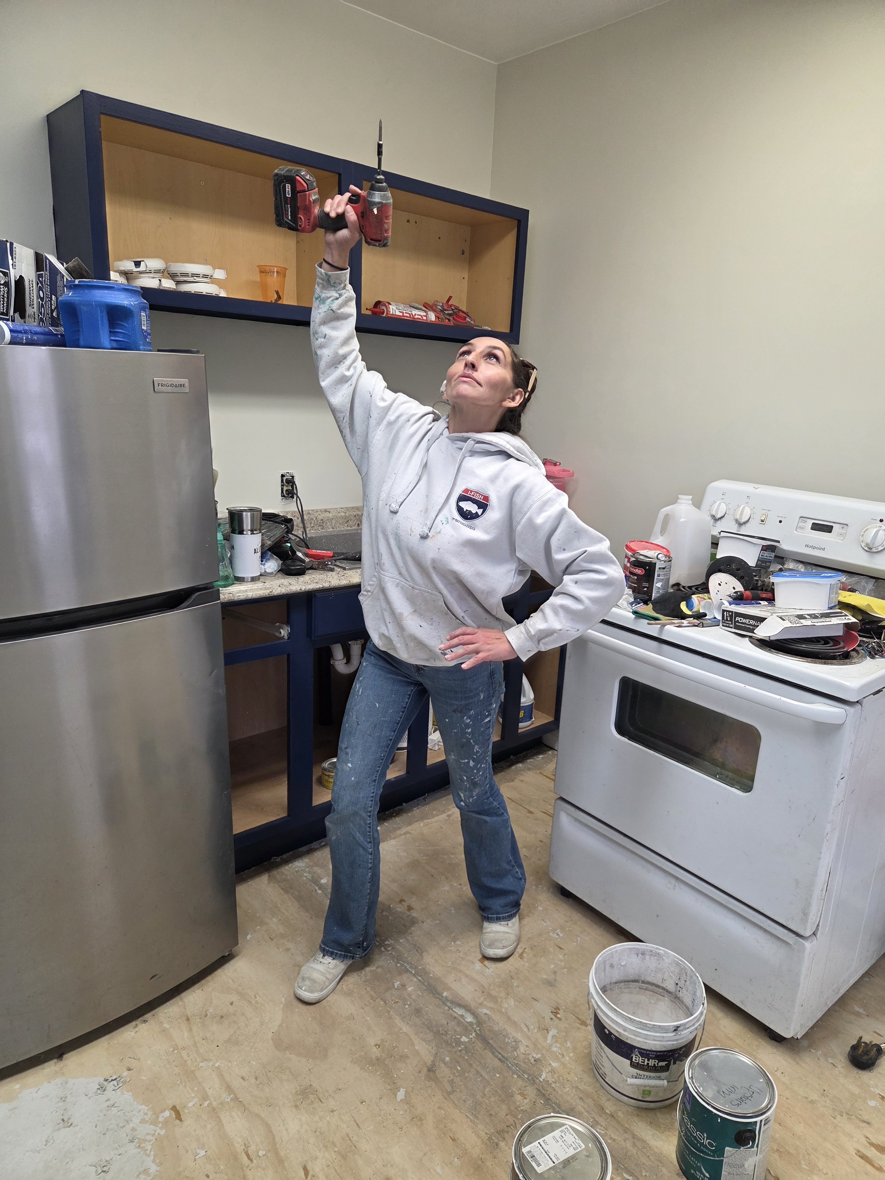 Morgana working with a drill, doing what she does best — building things